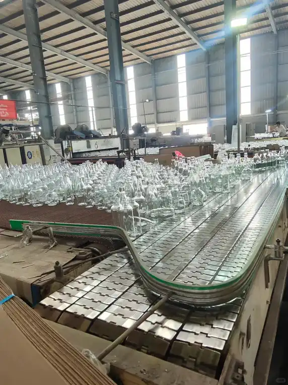 Glass bottles moving through a packaging production line