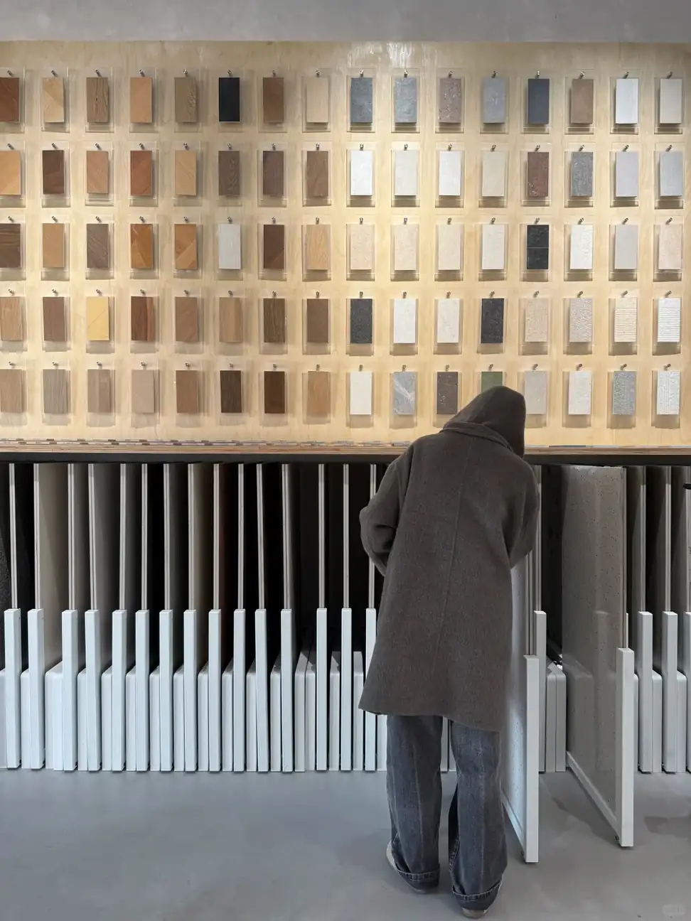 Buyer reviewing tile and surface samples in a Foshan showroom